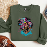a green sweatshirt with a picture of a woman with flowers on it
