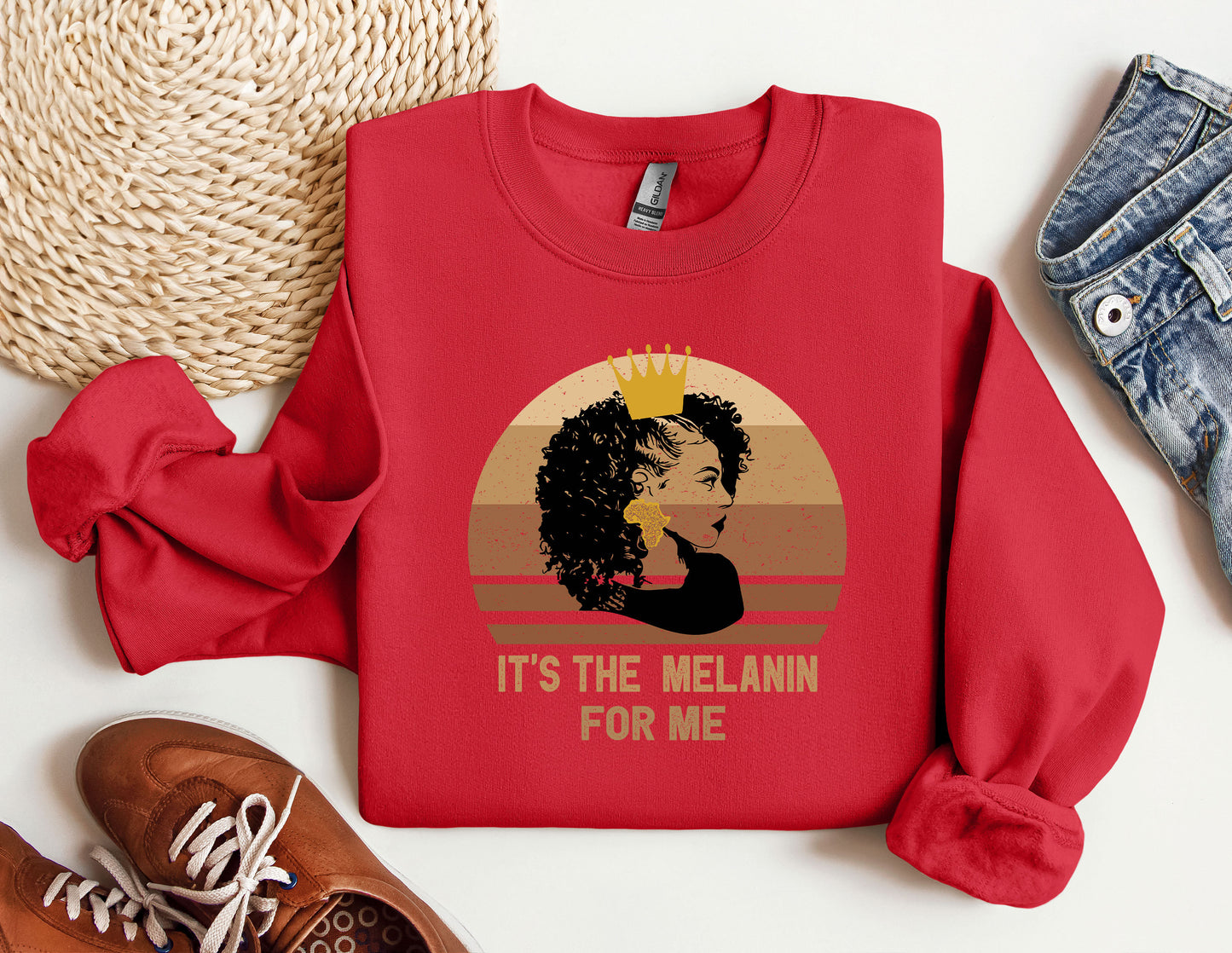 a red sweatshirt with a picture of a woman wearing a crown