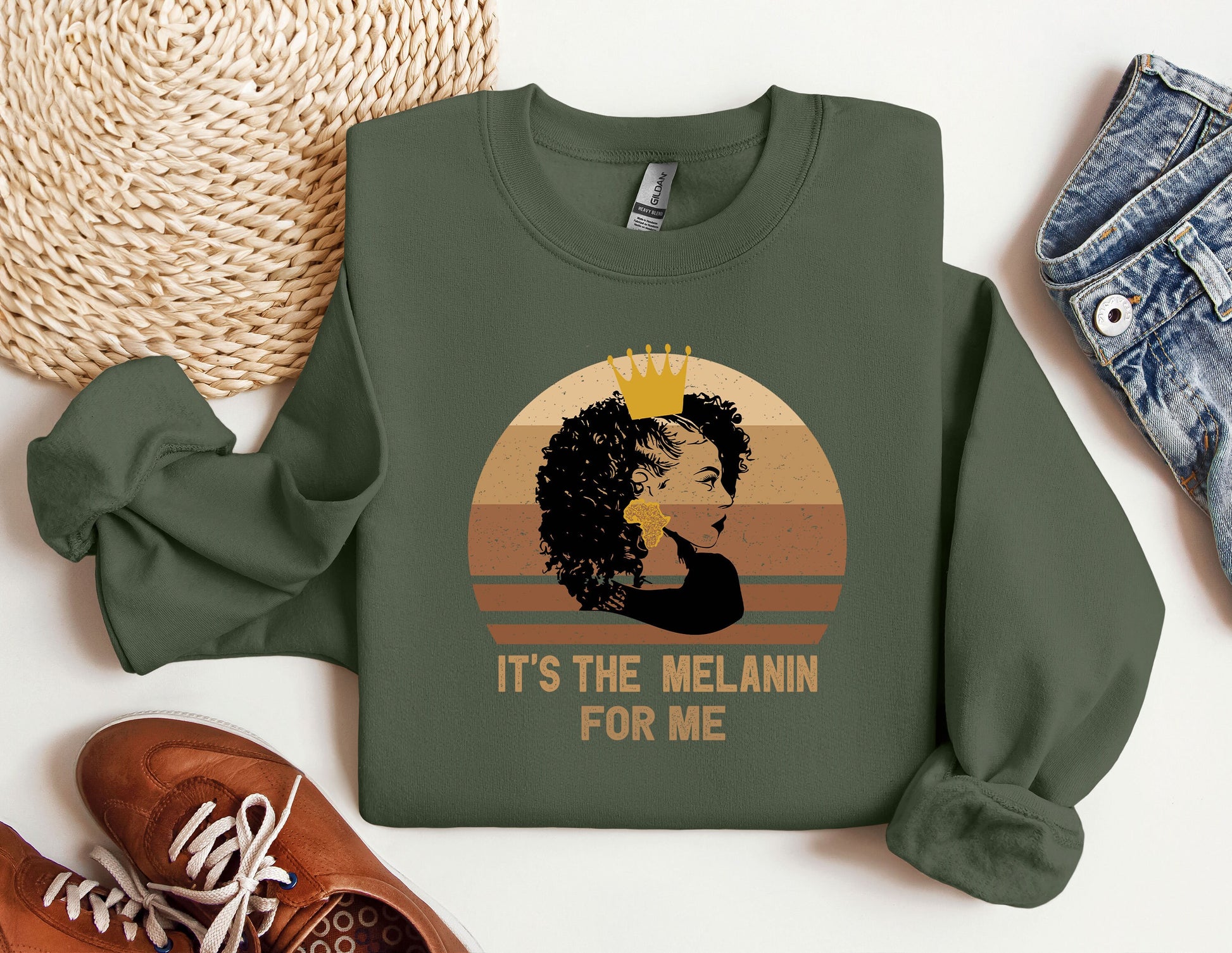 a green sweatshirt with a picture of a woman wearing a crown