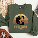 a green sweatshirt with a picture of a woman wearing a crown