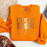 a pair of shoes and an orange shirt on a white surface