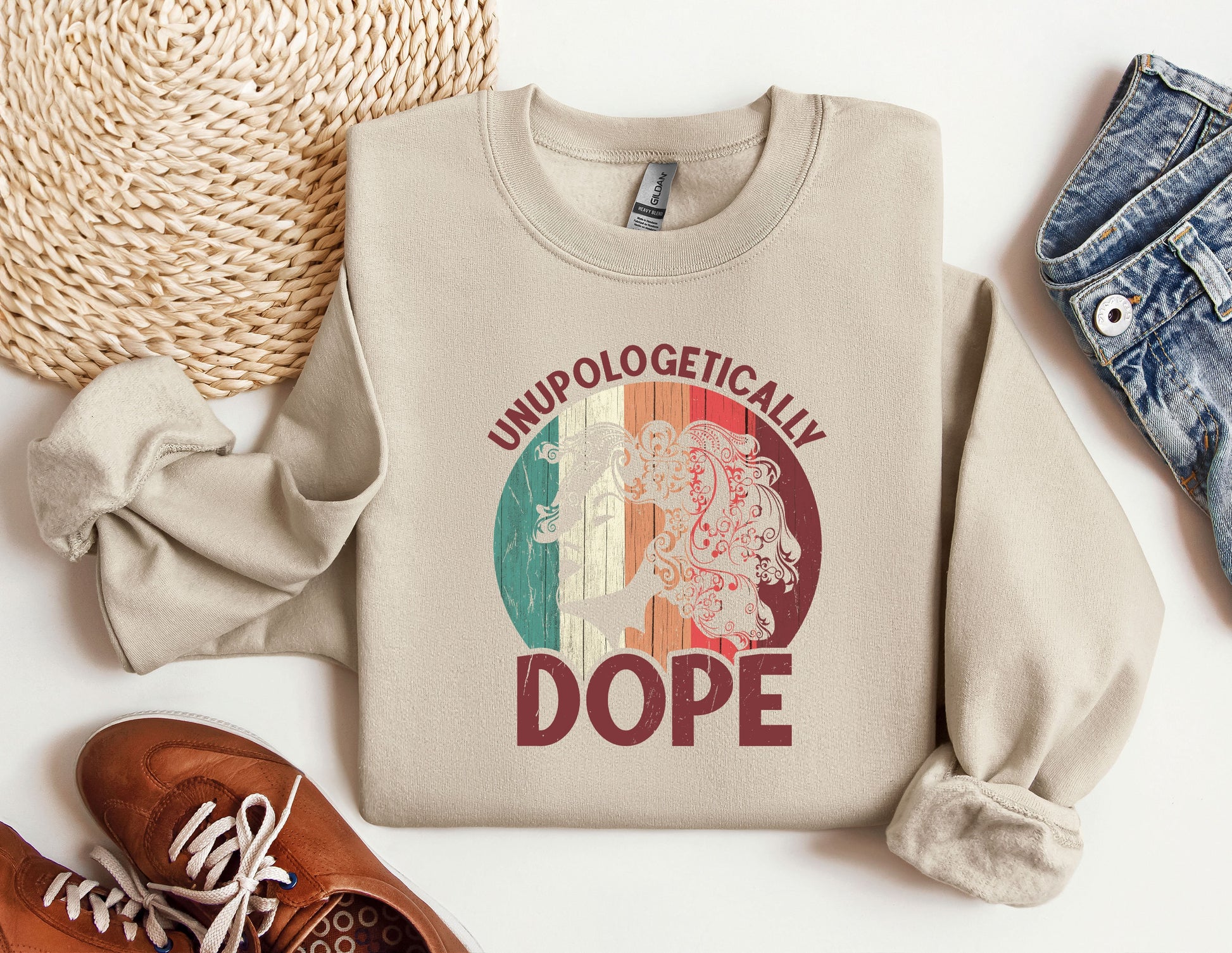 a sweater with a picture of a woman on it next to a pair of shoes