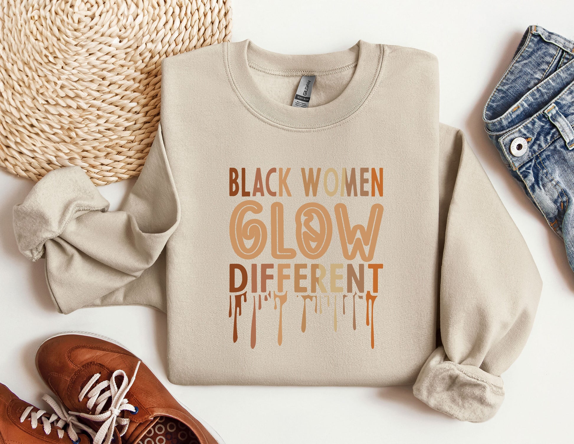 a sweater that says black women glow different colors