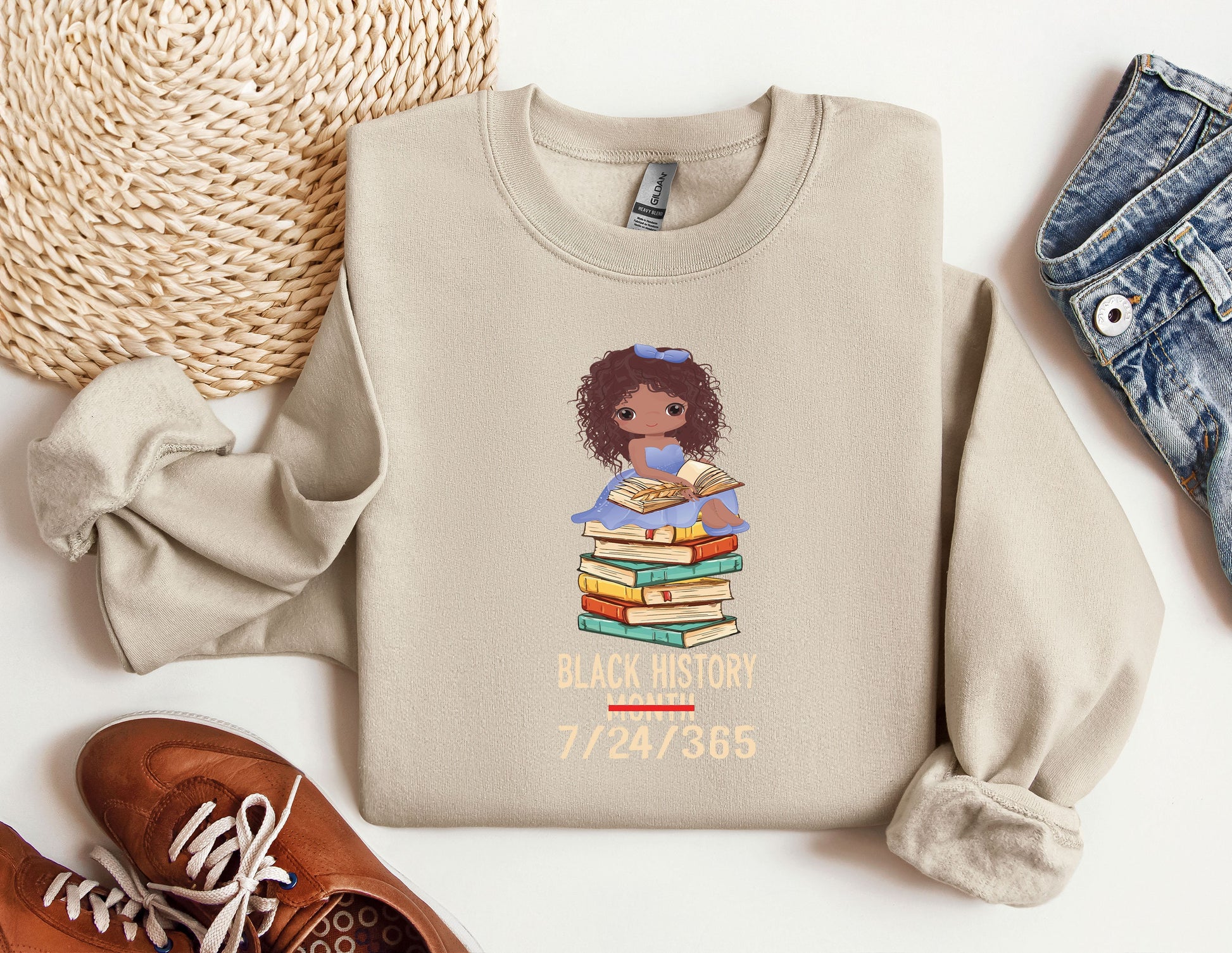 a sweater with a picture of a girl holding a stack of books