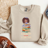 a sweater with a picture of a girl holding a stack of books