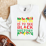 a white shirt with a colorful quote on it