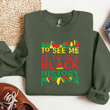 a green sweatshirt with the words to see me is to see black history