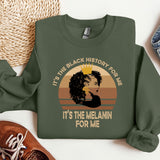 a green sweatshirt with a picture of a woman's face and the words it
