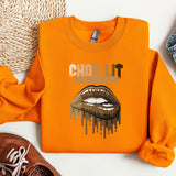 a pair of shoes and an orange shirt with a picture of a woman's