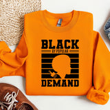 an orange shirt with a black - eyed woman on it