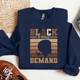a blue sweatshirt with a picture of a man's head and the words black
