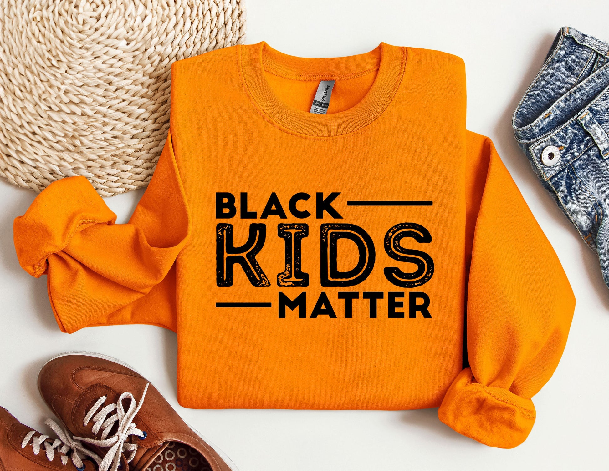 a black kids matter shirt next to a pair of sneakers