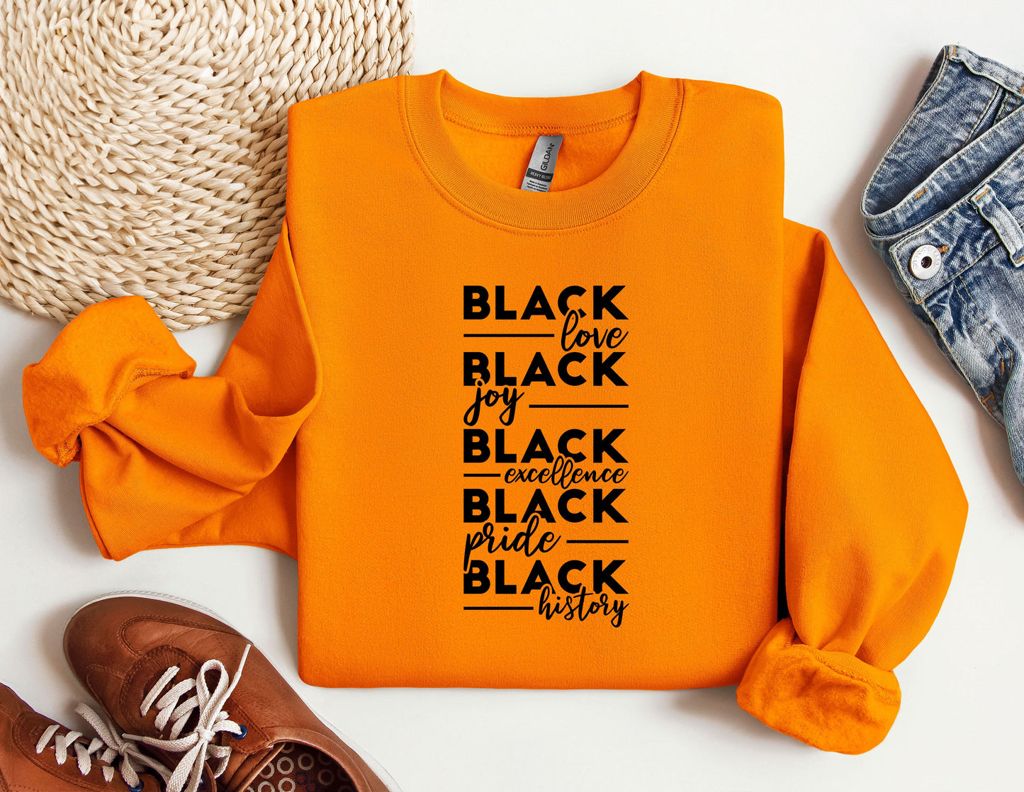 an orange shirt with black lettering on it