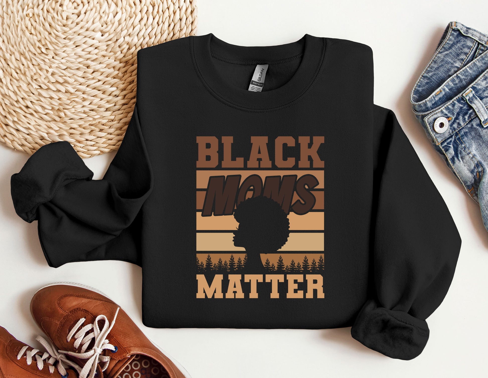 a black man&#39;s matter sweatshirt next to a pair of sneakers