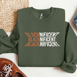 a green sweatshirt with the words black and white on it next to a pair of