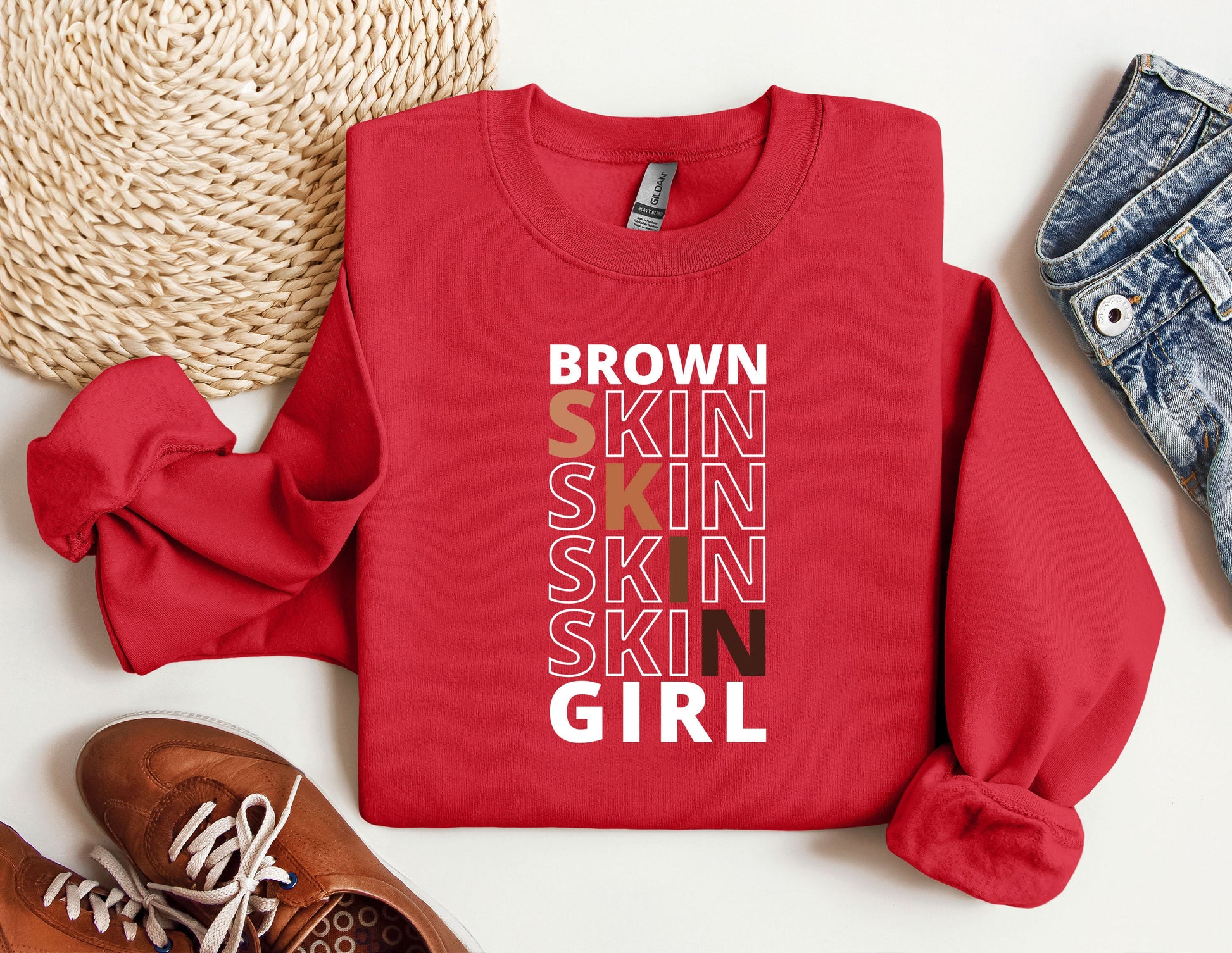 a red sweatshirt with the words brown skin skin skin skin girl on it