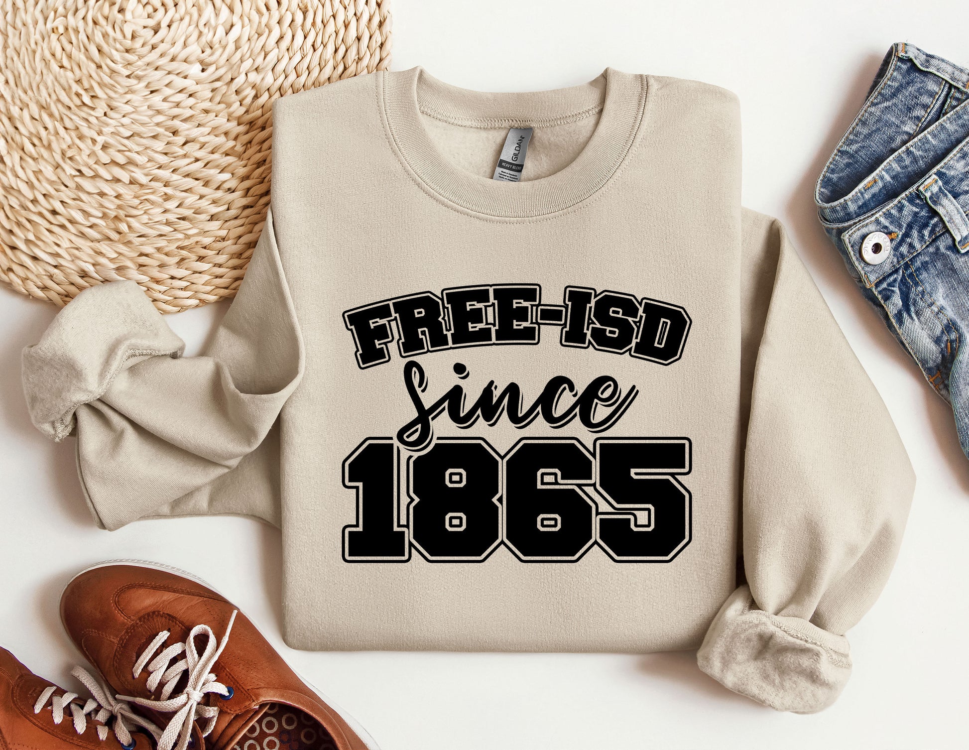 a sweater that says free - isd since 1965 next to a pair of shoes