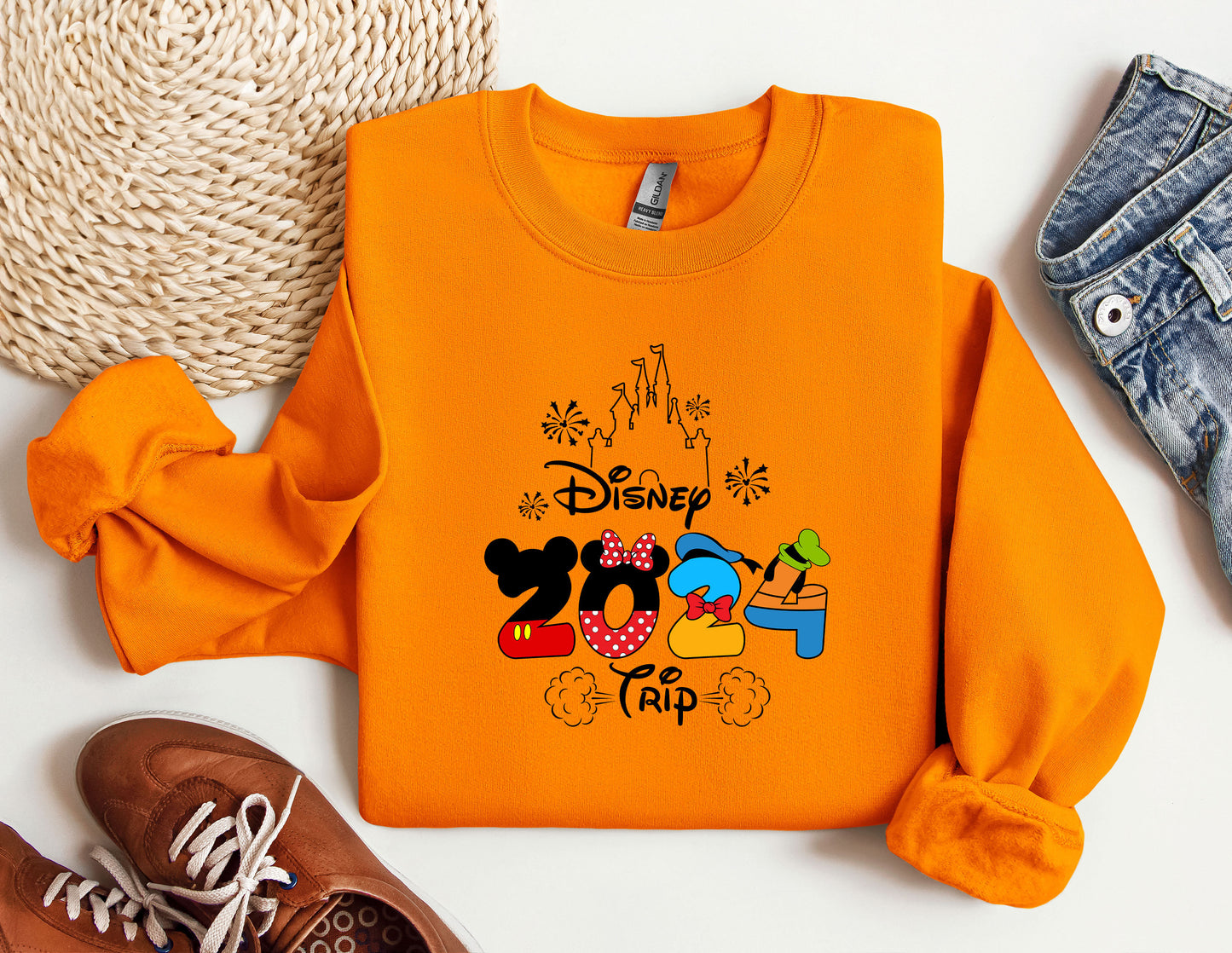 an orange shirt with a mickey mouse design on it