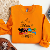 an orange shirt with a mickey mouse design on it