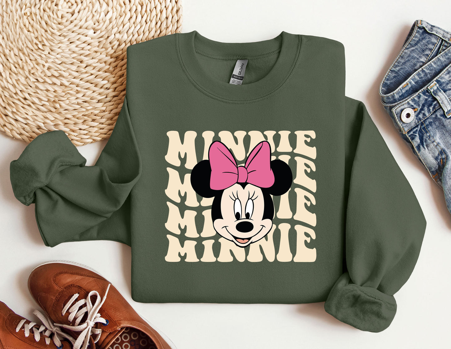 a green sweatshirt with minnie mouse on it