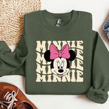 a green sweatshirt with minnie mouse on it