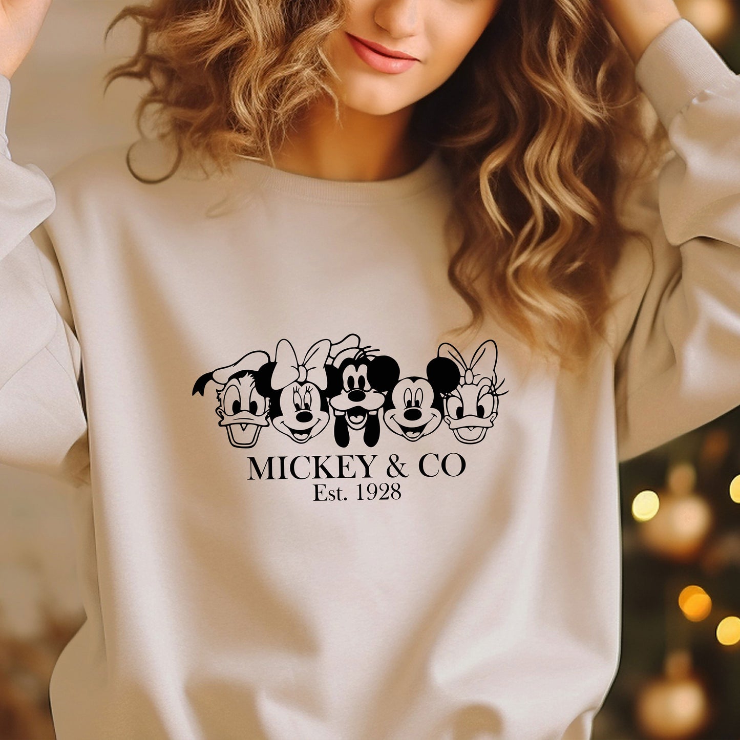 a woman wearing a mickey and mickey mouse sweatshirt