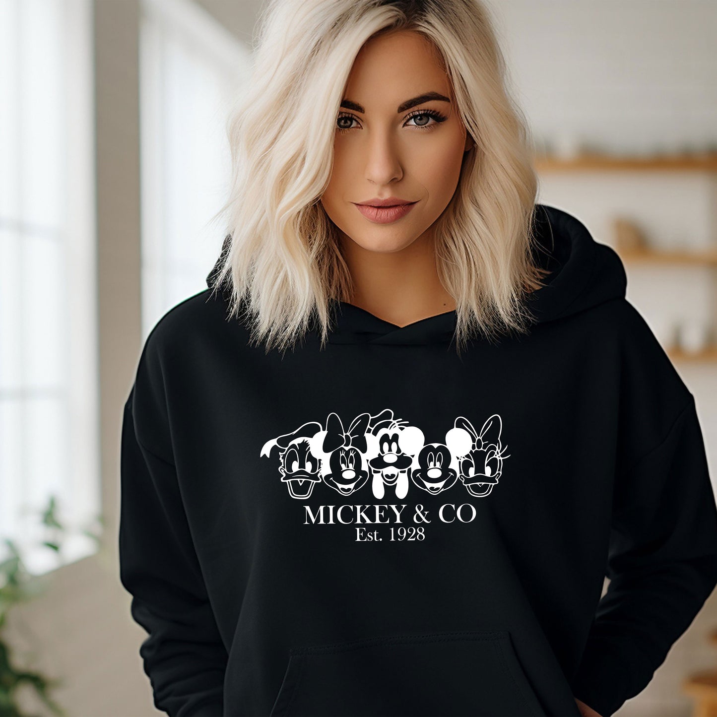 a woman wearing a mickey and co hoodie