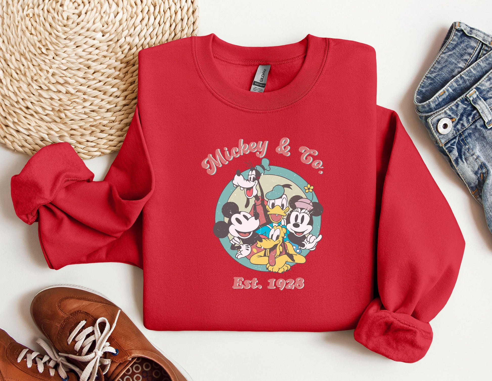 a red mickey and mickey mouse shirt next to a pair of shoes