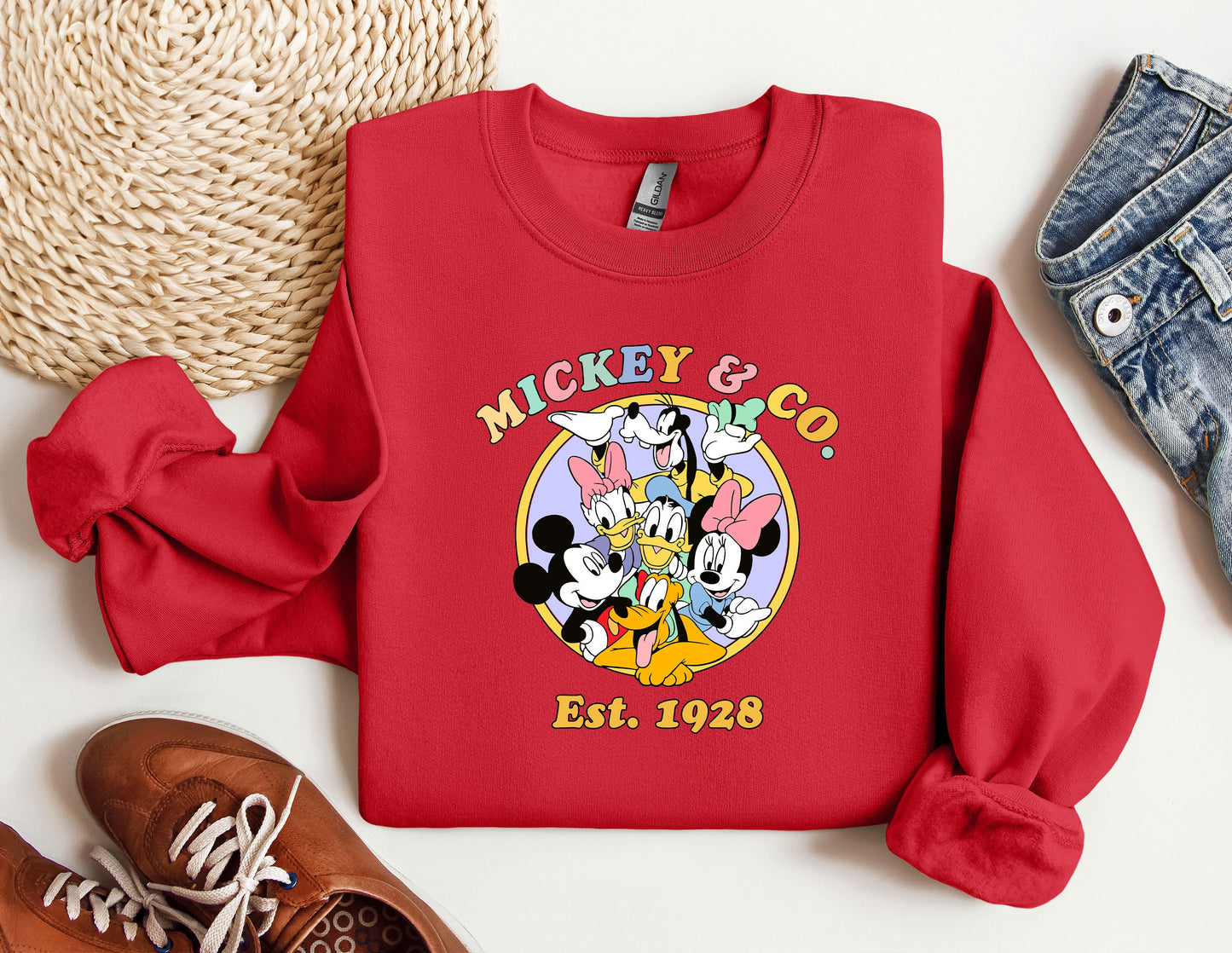 a mickey and mickey mouse shirt next to a pair of sneakers