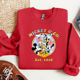 a mickey and mickey mouse shirt next to a pair of sneakers