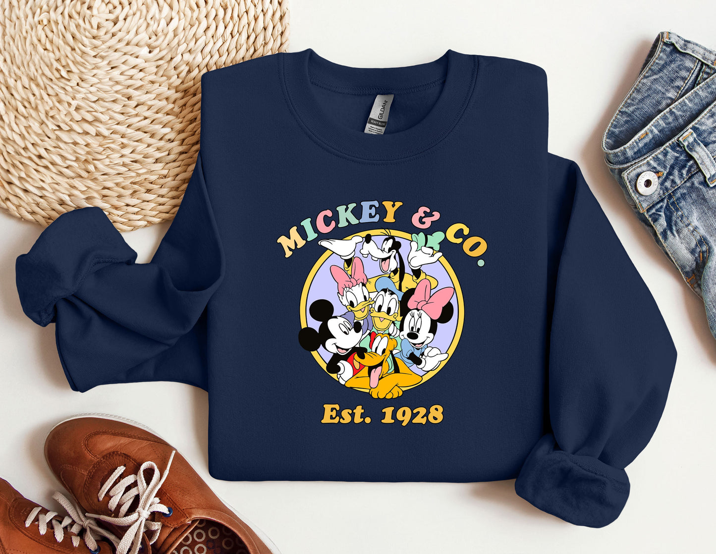 a mickey and mickey mouse shirt next to a pair of sneakers