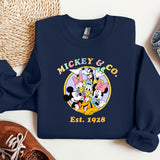 a mickey and mickey mouse shirt next to a pair of sneakers