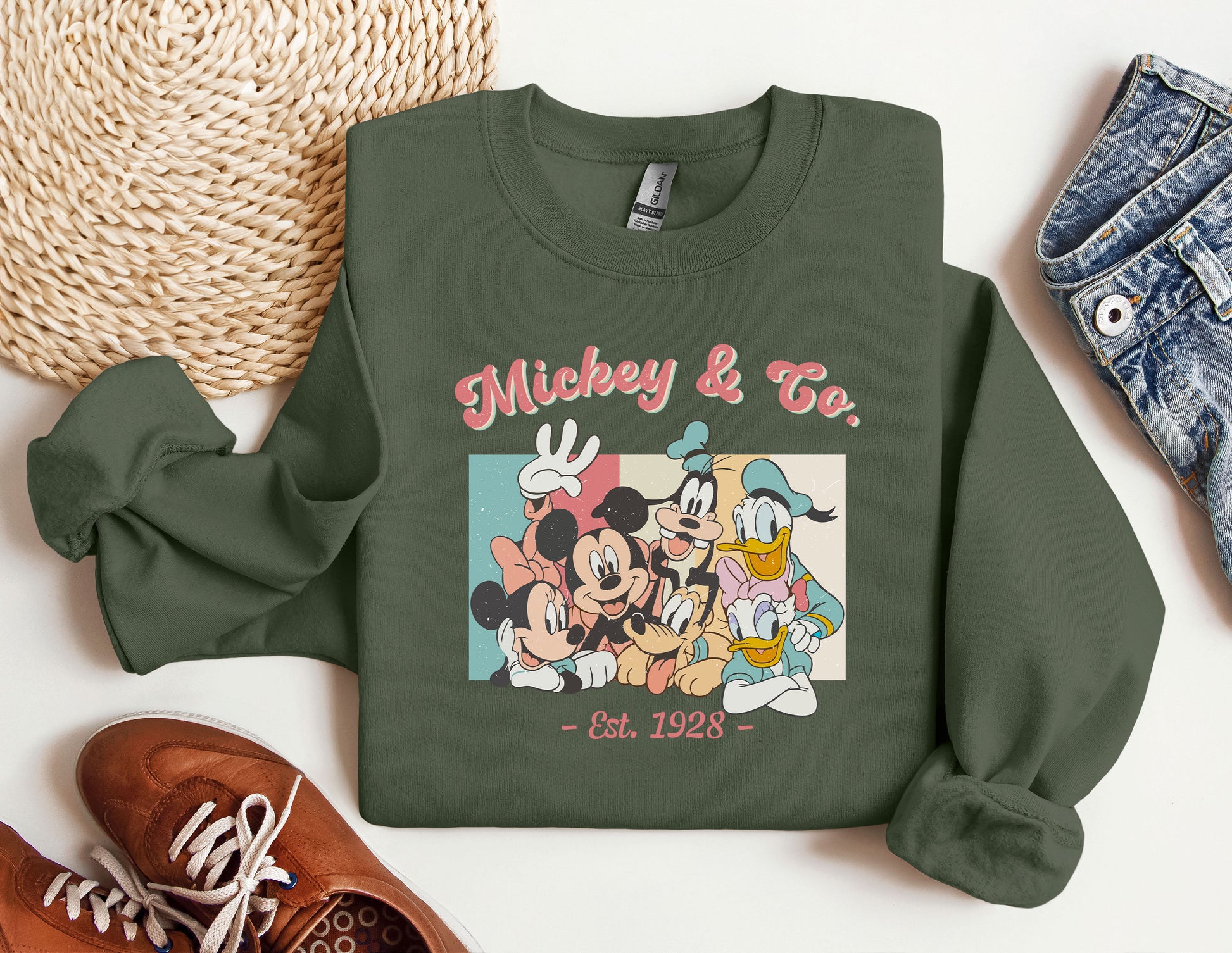 a green sweatshirt with mickey and friends on it