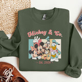 a green sweatshirt with mickey and friends on it