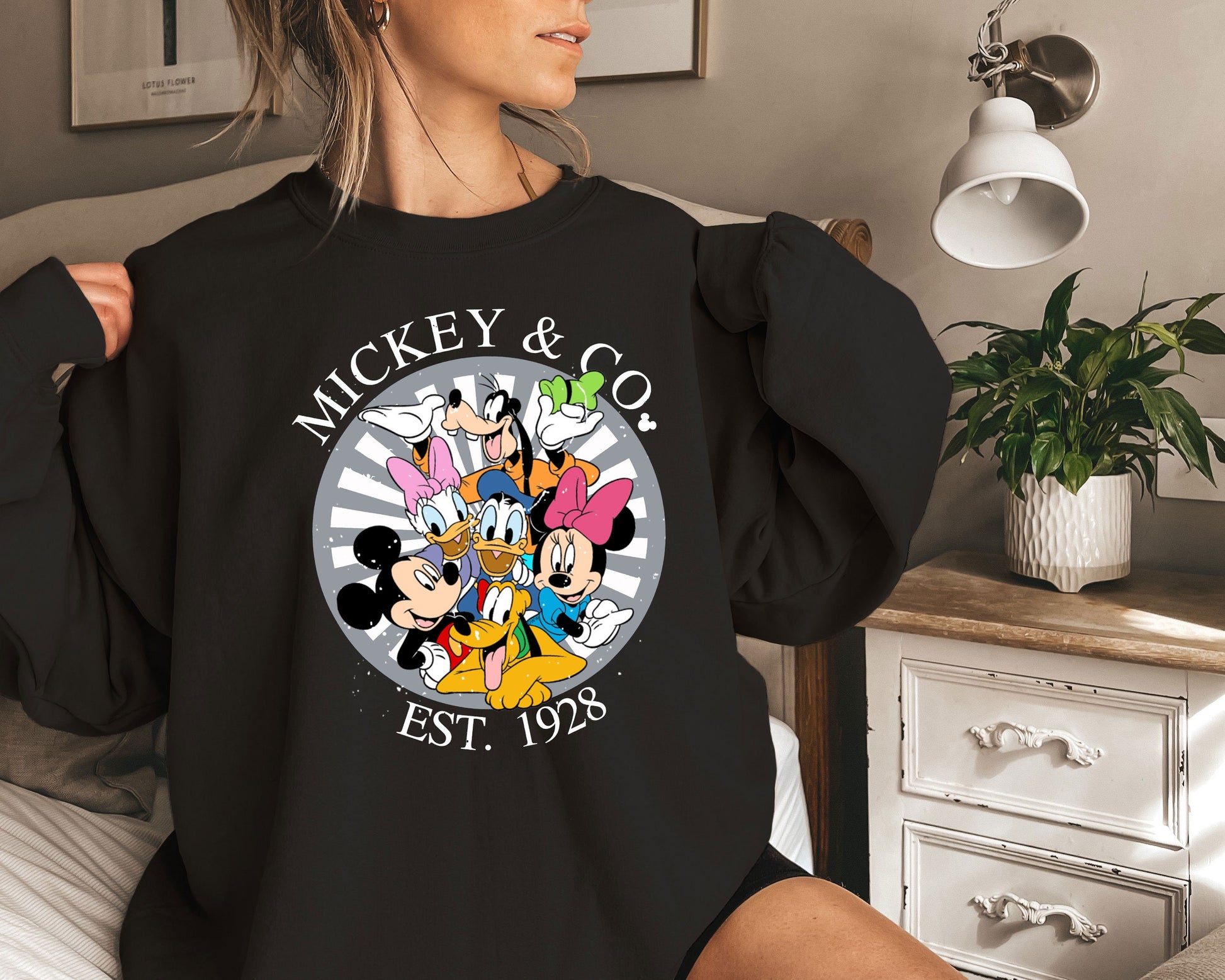 a woman wearing a mickey and mickey mouse shirt