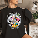 a woman wearing a mickey and mickey mouse shirt
