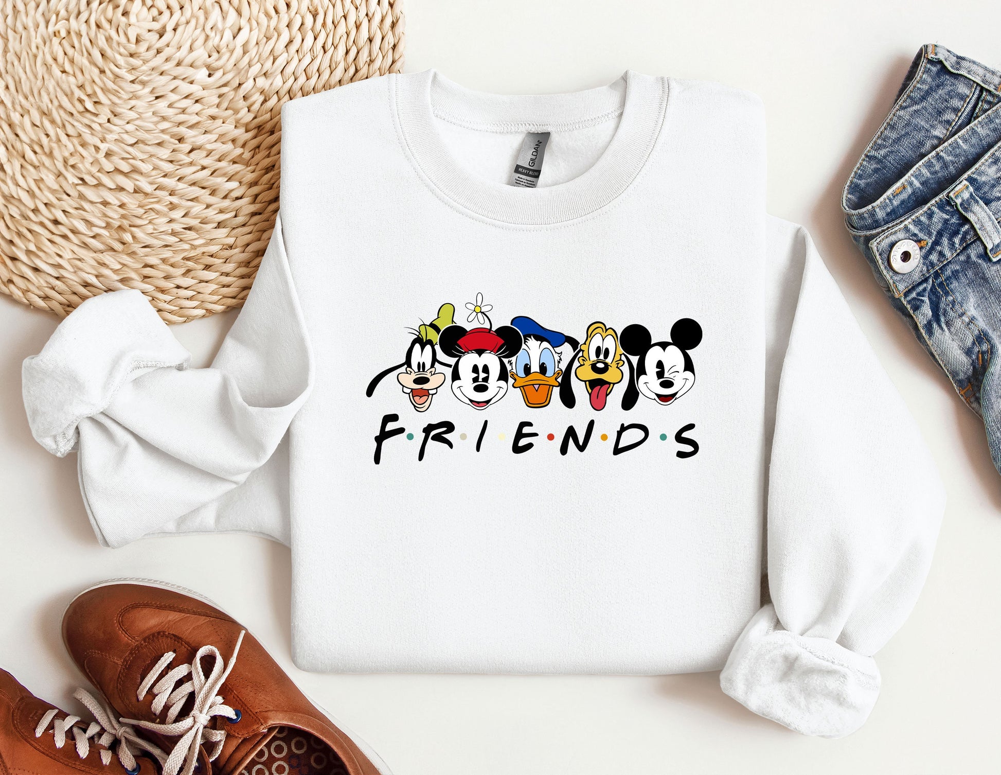 a white sweatshirt with mickey mouse friends on it