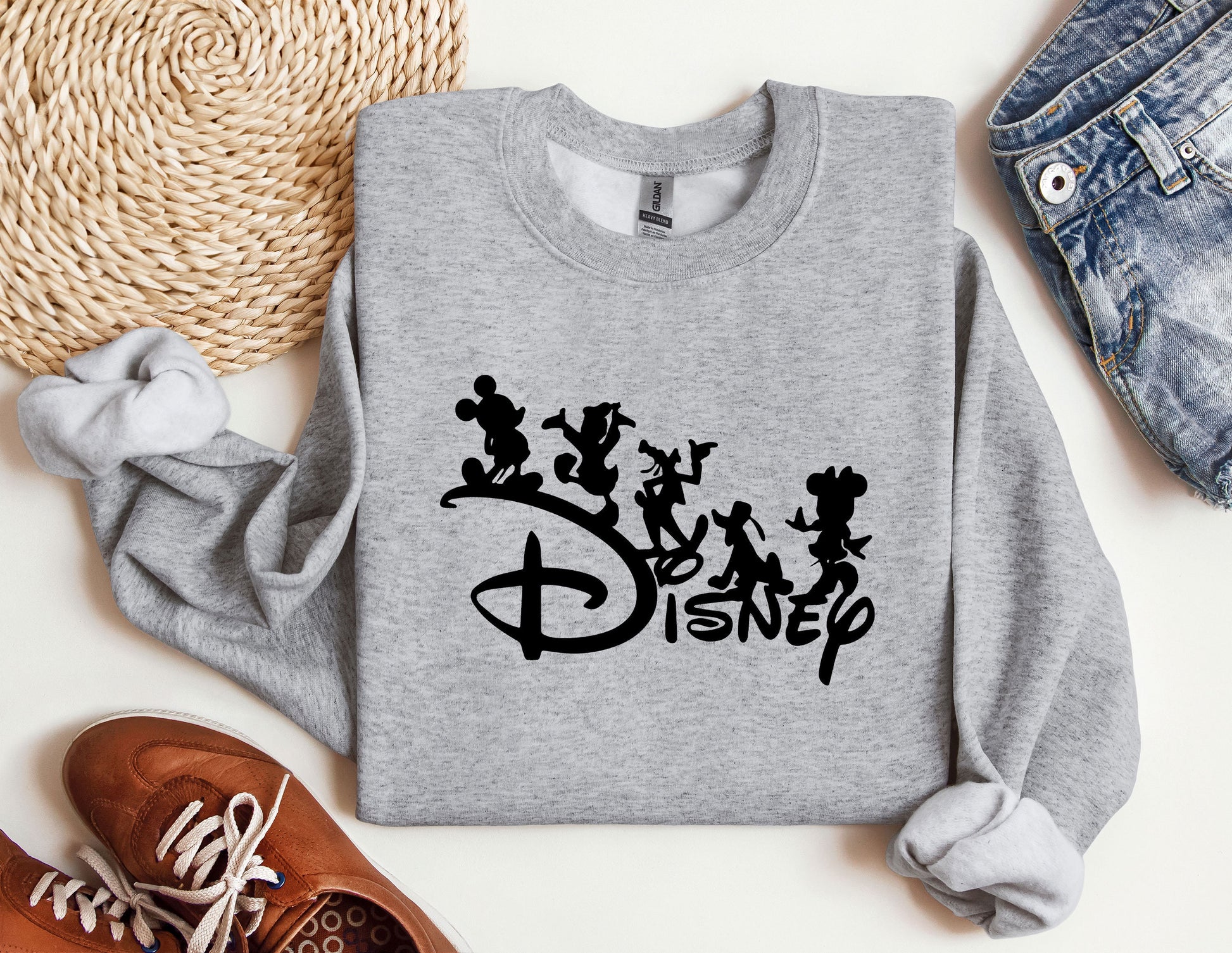 a sweatshirt with mickey mouse and other disney characters on it