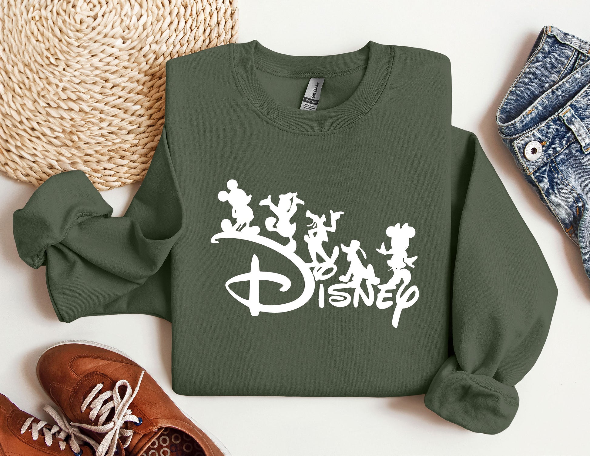 a green sweatshirt with disney characters on it