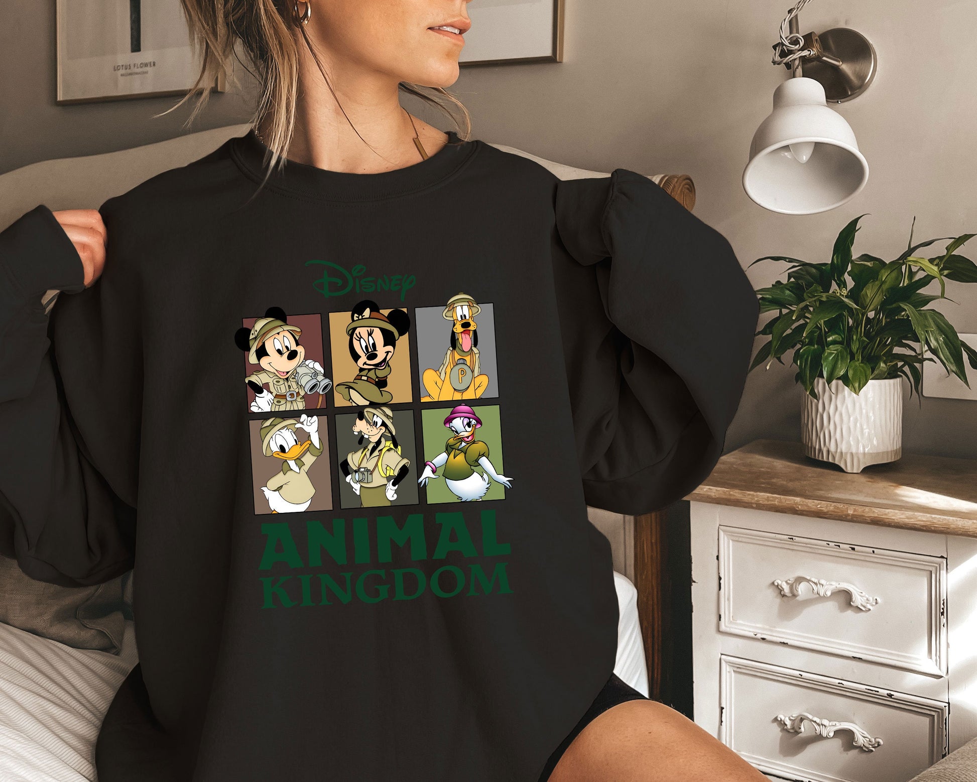 a woman is sitting on a bed wearing a black shirt