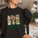 a woman is sitting on a bed wearing a black shirt