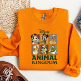 an orange shirt with mickey mouse and other disney characters on it