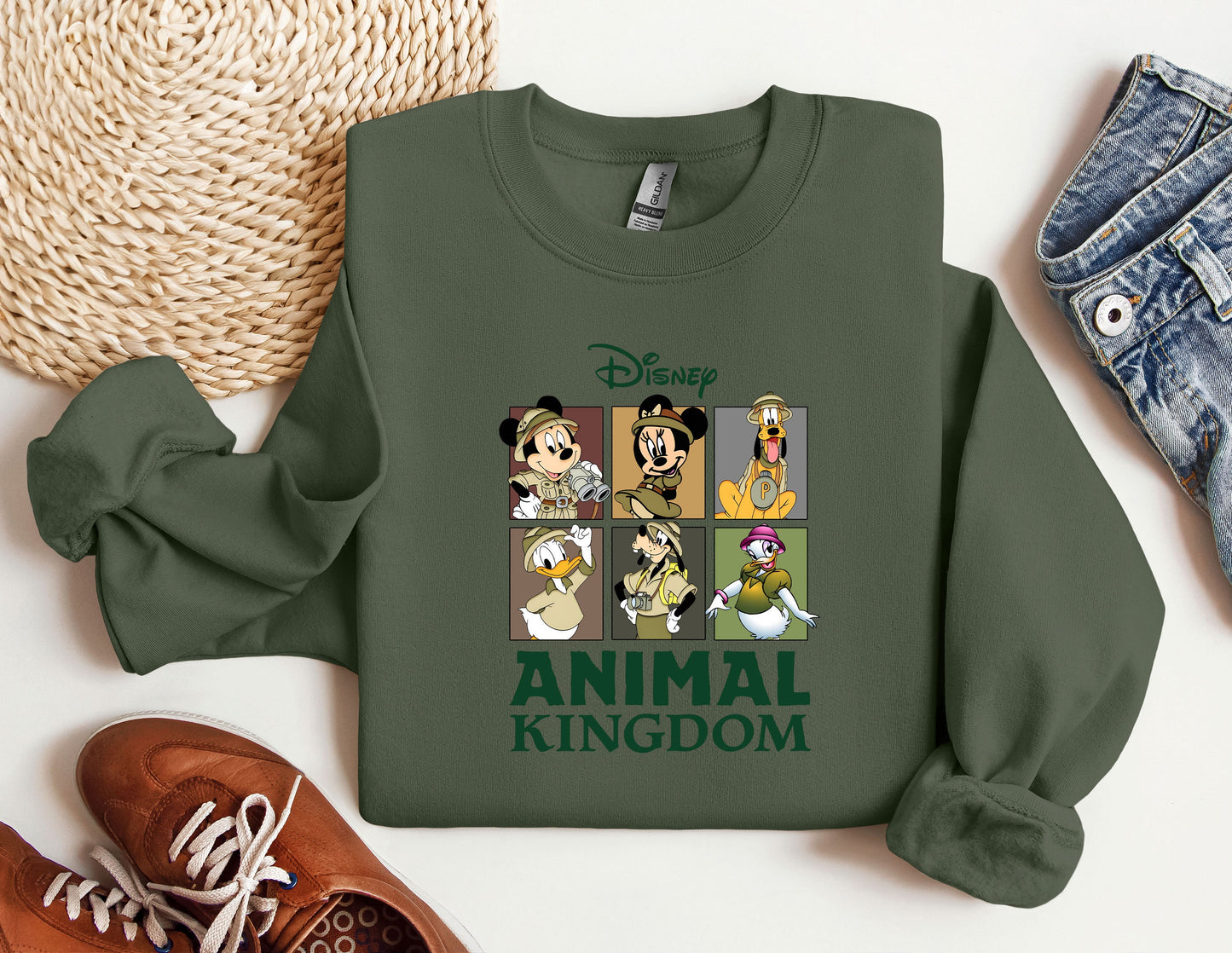 a green sweatshirt with a picture of mickey mouse and other disney characters