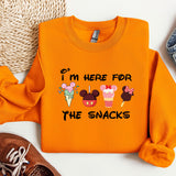 a pair of sneakers and an orange sweatshirt with mickey mouse on it