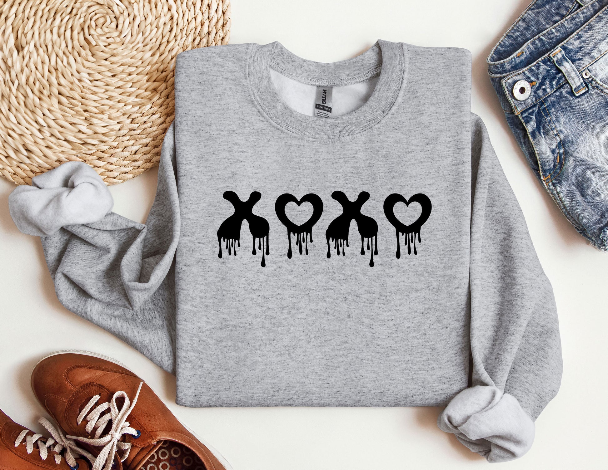 a sweater with the word xo on it next to a pair of shoes