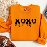 a pair of shoes and an orange shirt with the word xo on it