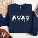 a blue sweatshirt with white paint dripping down it