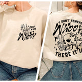 a woman wearing a white sweatshirt with a skull on it