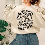 a woman wearing a sweatshirt with a skull on it