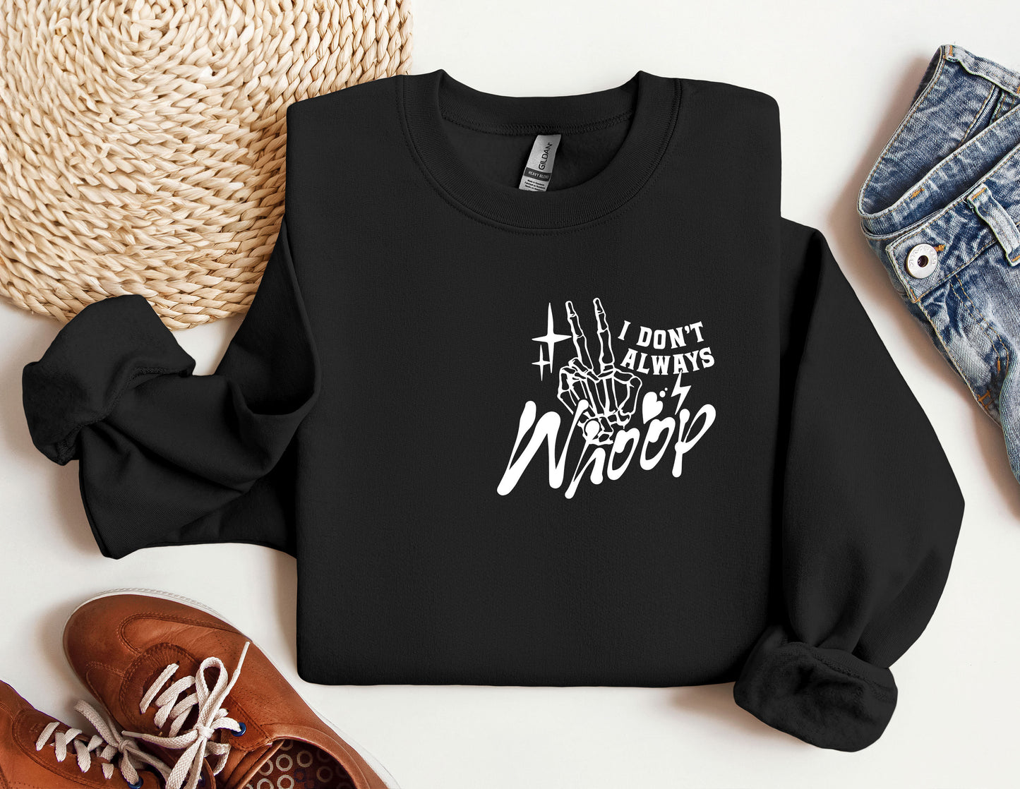 a black sweatshirt with white writing on it next to a pair of shoes